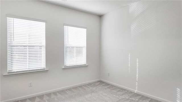 spare room with light colored carpet