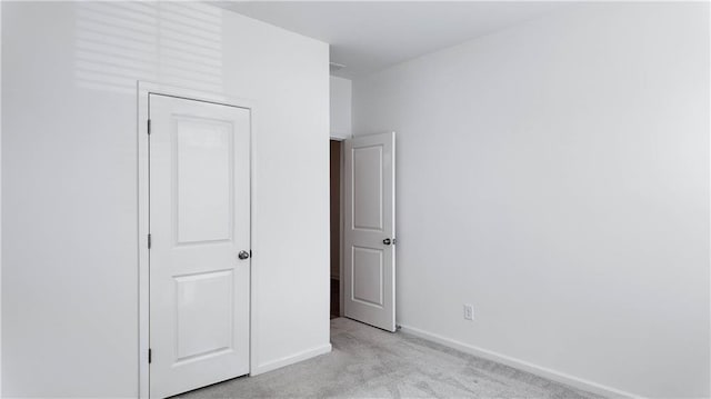 unfurnished bedroom featuring light carpet