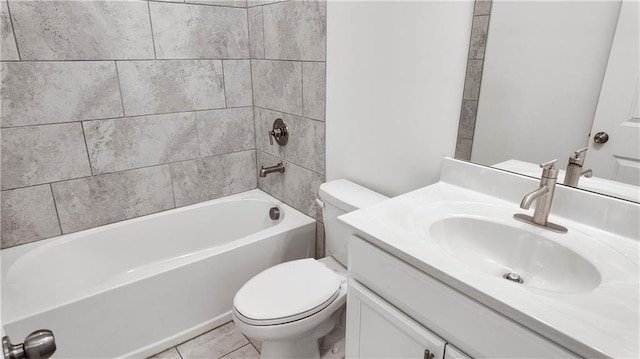 full bathroom with tiled shower / bath, tile patterned flooring, vanity, and toilet