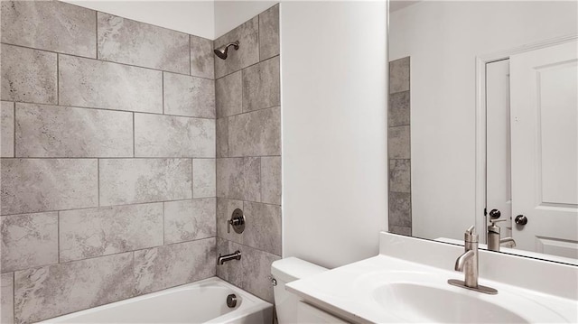 full bathroom with vanity, tiled shower / bath combo, and toilet