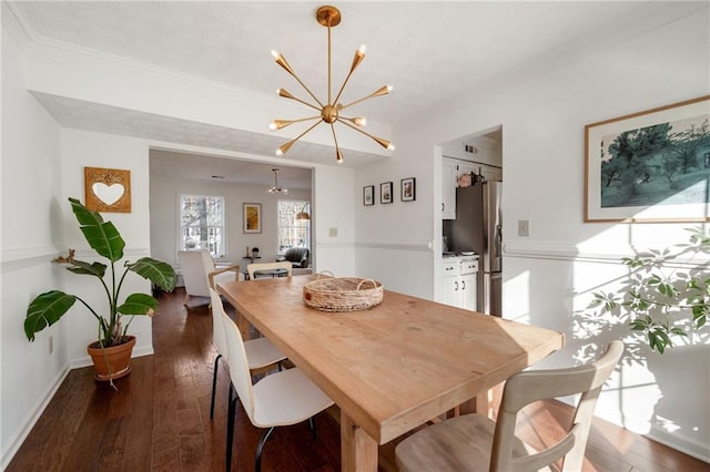 dining room featuring ornamental molding, dark hardwood / wood-style floors, and a notable chandelier