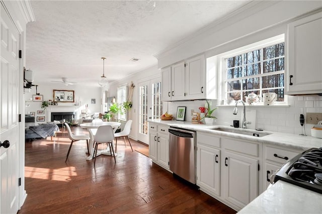 kitchen with white cabinetry, dishwasher, hanging light fixtures, and sink