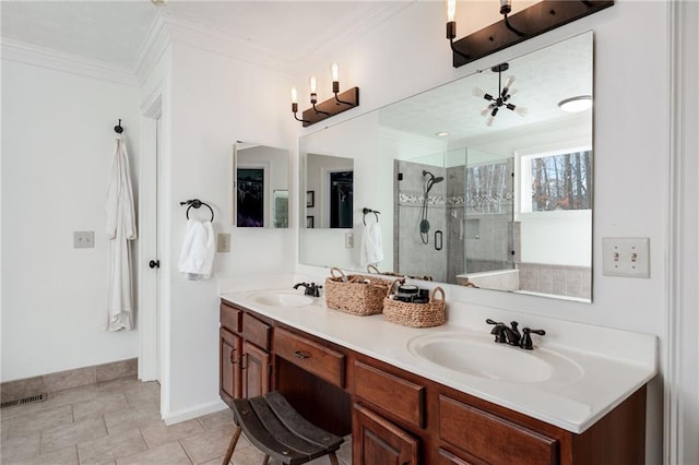 bathroom featuring tile patterned flooring, ornamental molding, vanity, and a shower with shower door