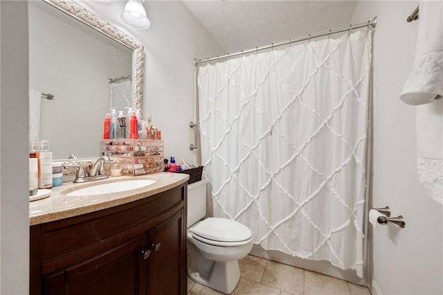 bathroom featuring tile patterned flooring, vanity, and toilet