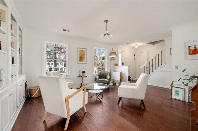 sitting room with an inviting chandelier, crown molding, and dark hardwood / wood-style floors