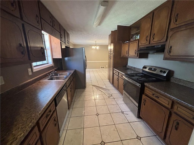 440 Ward Rd, Ellenwood, GA 30294 - kitchen with stainless steel appliances, under cabinet range hood, a sink, dark countertops, and a textured ceiling