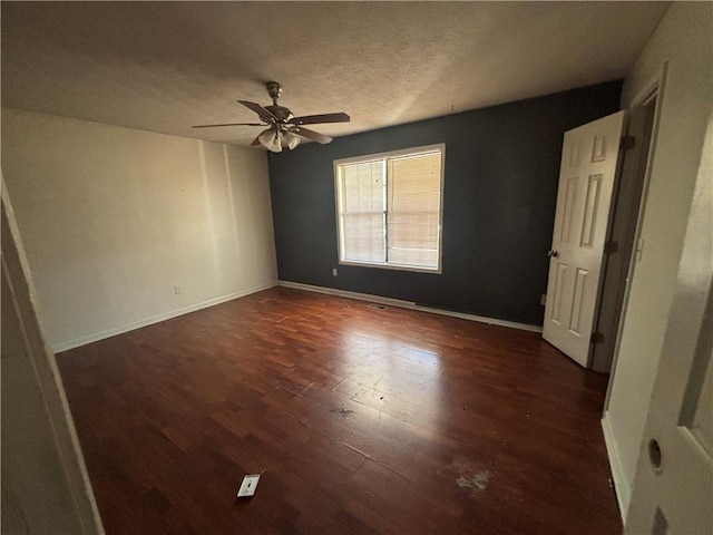 440 Ward Rd, Ellenwood, GA 30294 - unfurnished bedroom with wood finished floors, a ceiling fan, baseboards, and a textured ceiling