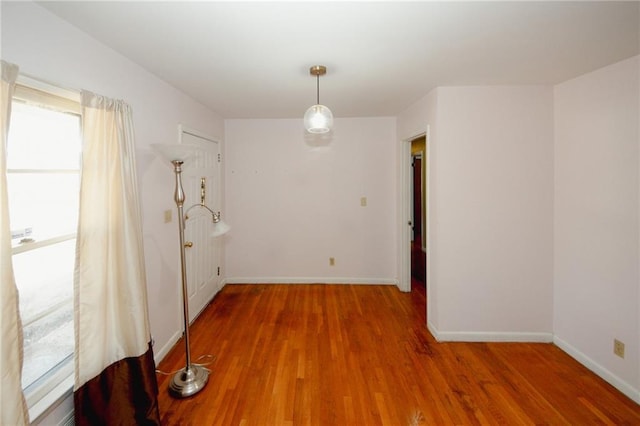 unfurnished dining area featuring hardwood / wood-style floors