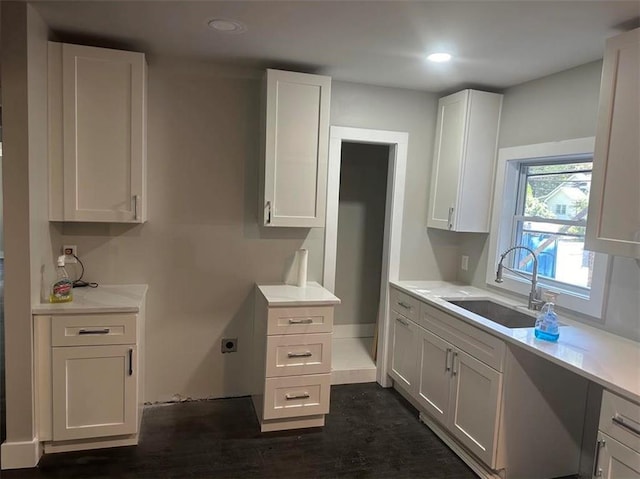 kitchen with white cabinets, dark hardwood / wood-style floors, and sink