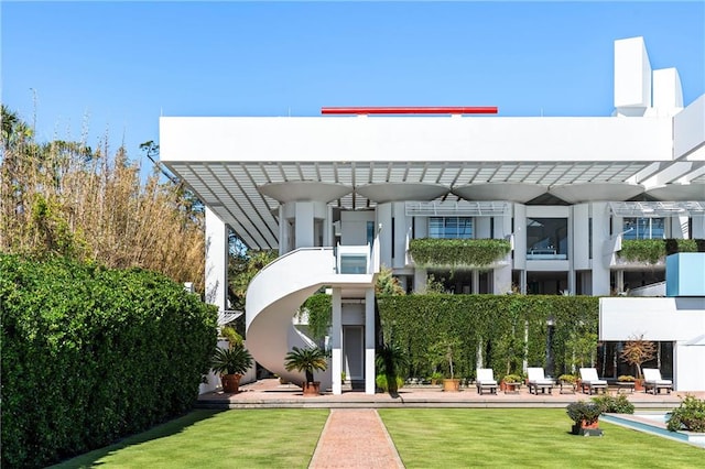 exterior space with a patio and a front lawn