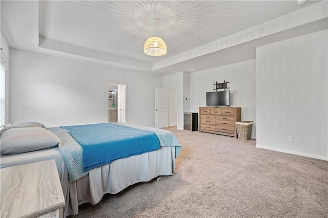 bedroom with baseboards, carpet floors, and a tray ceiling