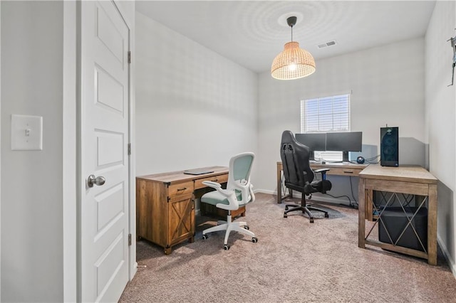 carpeted home office featuring visible vents and baseboards