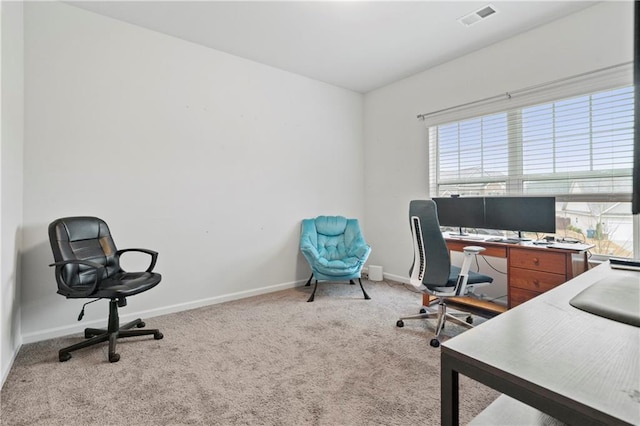 carpeted home office with visible vents and baseboards