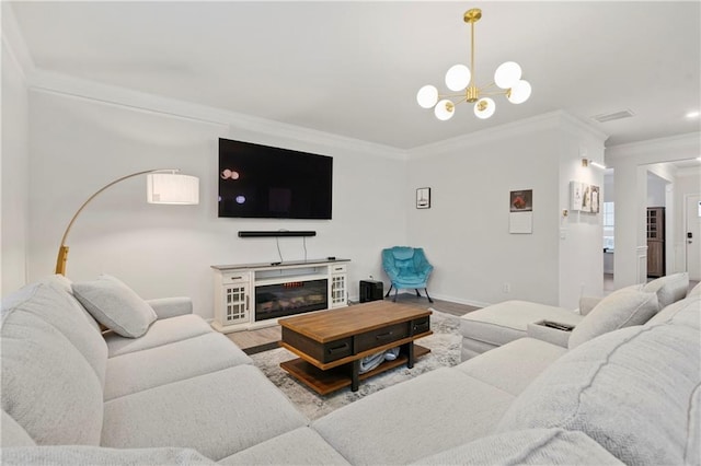 living room with light wood-type flooring, ornamental molding, and an inviting chandelier