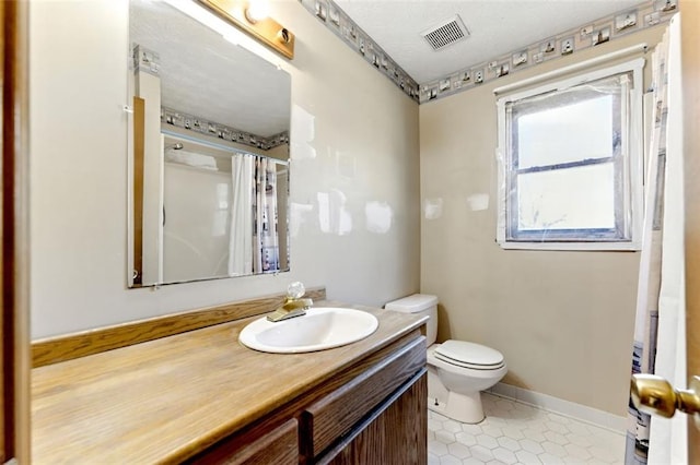 full bathroom with visible vents, toilet, vanity, tile patterned flooring, and baseboards