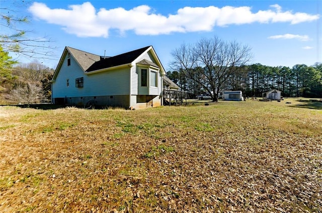 view of property exterior featuring crawl space and a lawn