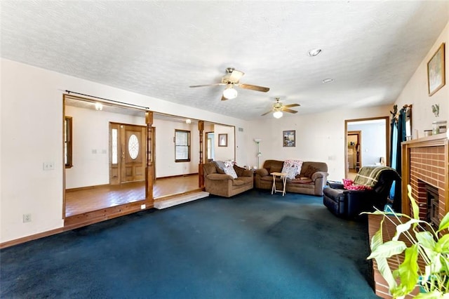 interior space with carpet floors, a fireplace, baseboards, and a textured ceiling