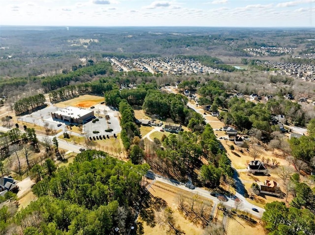 birds eye view of property featuring a wooded view