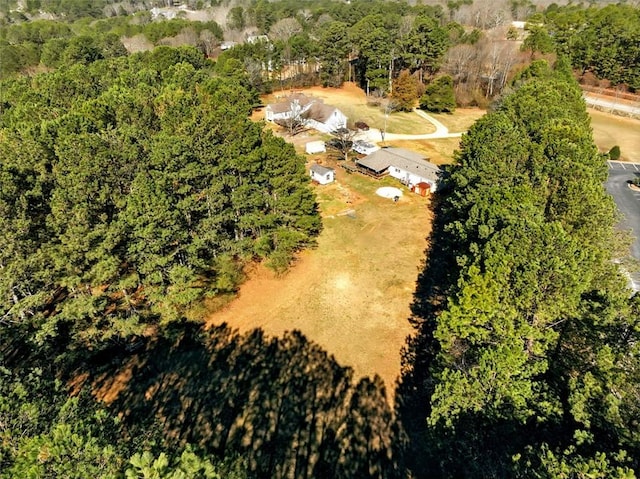 drone / aerial view with a wooded view