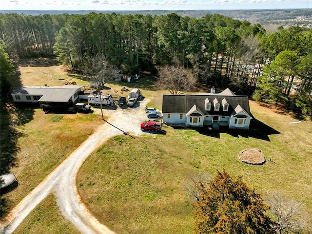 drone / aerial view with a wooded view