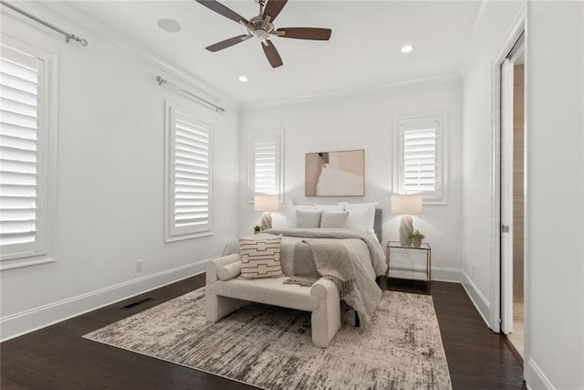 bedroom featuring visible vents, baseboards, dark wood finished floors, recessed lighting, and crown molding