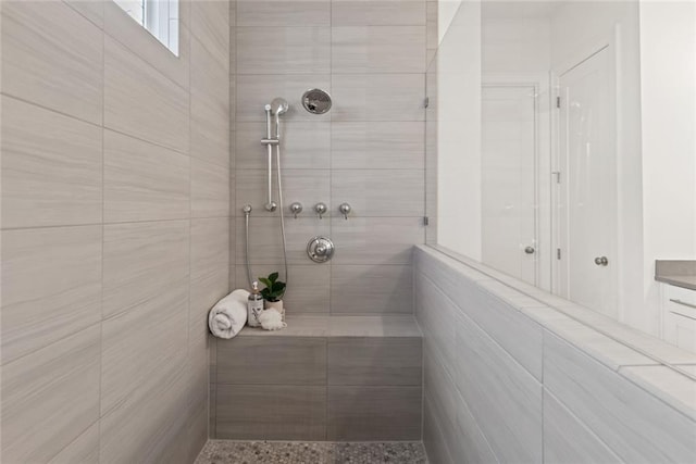 bathroom with tiled shower