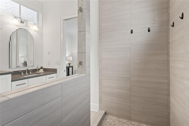 full bathroom with vanity and tiled shower