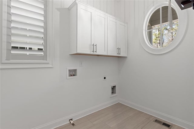 laundry room with visible vents, baseboards, cabinet space, electric dryer hookup, and washer hookup