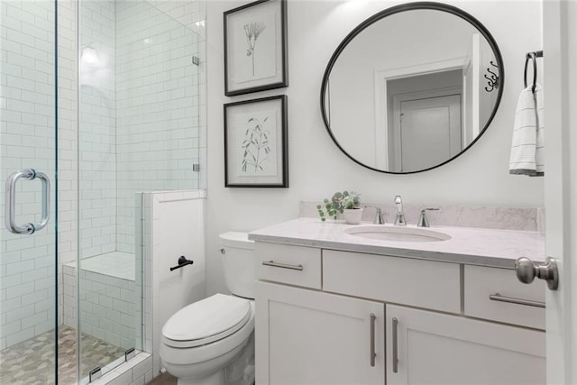 full bath with vanity, toilet, and a shower stall