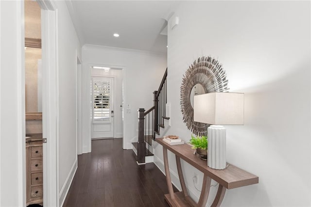 corridor featuring crown molding, baseboards, stairway, hardwood / wood-style floors, and recessed lighting