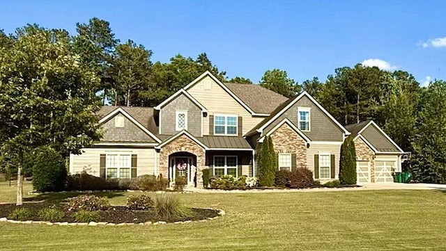 265 Enfield Ln, Mcdonough, GA 30252 - craftsman-style home featuring stone siding, a front yard, concrete driveway, and a standing seam roof