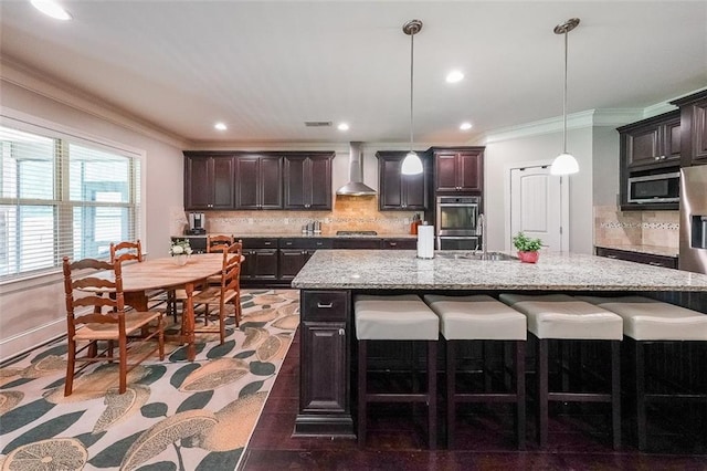 265 Enfield Ln, Mcdonough, GA 30252 - kitchen featuring wall chimney range hood, a kitchen bar, ornamental molding, decorative backsplash, and a sink