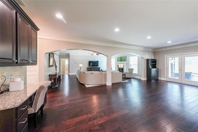 265 Enfield Ln, Mcdonough, GA 30252 - living area featuring ornamental molding, dark wood-type flooring, healthy amount of natural light, arched walkways, and recessed lighting