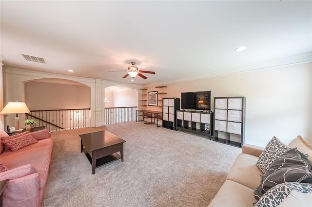 265 Enfield Ln, Mcdonough, GA 30252 - carpeted living room with crown molding, ceiling fan, arched walkways, and recessed lighting