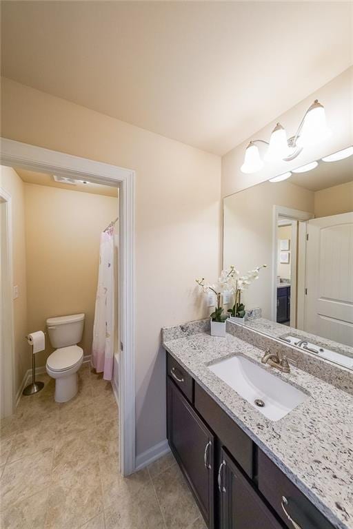 265 Enfield Ln, Mcdonough, GA 30252 - bathroom featuring vanity, toilet, baseboards, tile patterned flooring, and shower / bathtub combination with curtain