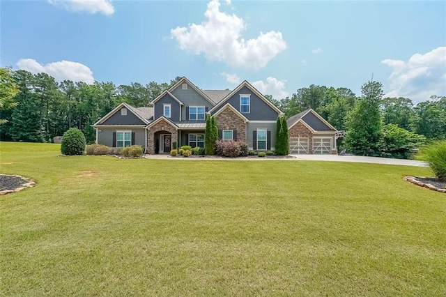 265 Enfield Ln, Mcdonough, GA 30252 - craftsman-style home with a front yard, driveway, an attached garage, and stone siding