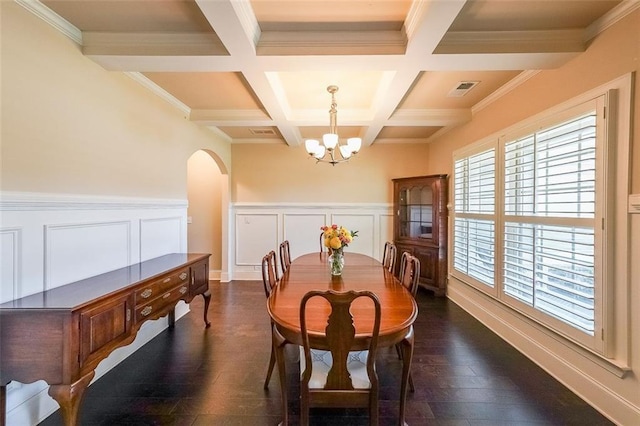 265 Enfield Ln, Mcdonough, GA 30252 - dining space featuring a chandelier, beamed ceiling, arched walkways, dark wood-style floors, and coffered ceiling