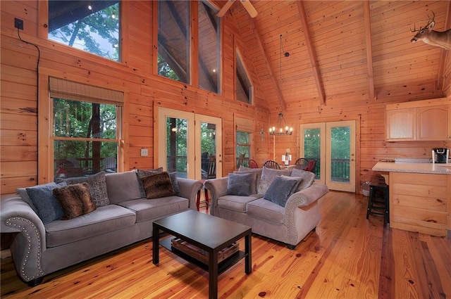 2374 Woodring Branch Rd, Chatsworth, GA 30705 - living room with high vaulted ceiling, wood walls, plenty of natural light, light wood-style floors, and a chandelier