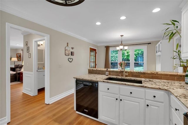 kitchen with ornamental molding, black dishwasher, white cabinetry, a sink, and backsplash