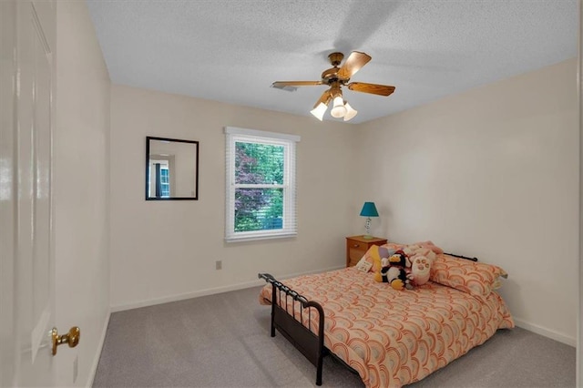 bedroom with carpet floors, baseboards, a ceiling fan, and a textured ceiling