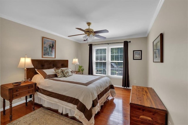 bedroom with crown molding, a ceiling fan, baseboards, and wood finished floors