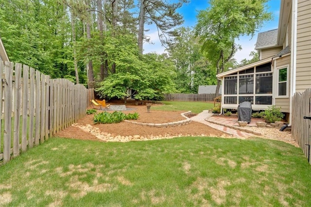 view of yard featuring a fenced backyard and a sunroom