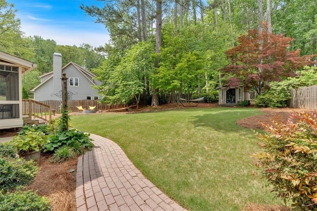 view of yard featuring fence and a sunroom