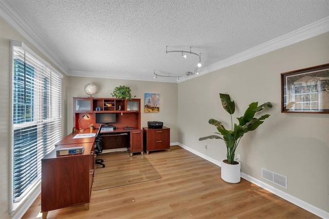 office with visible vents, rail lighting, a textured ceiling, and crown molding