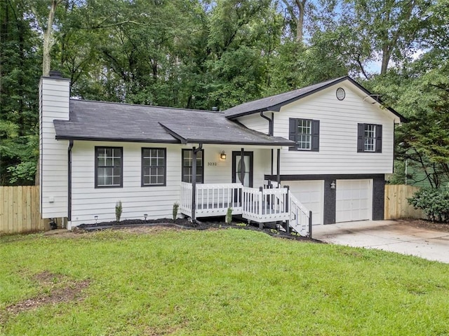 3232 Valley View St, Powder Springs, GA 30127 - split level home featuring a porch, a chimney, an attached garage, and concrete driveway