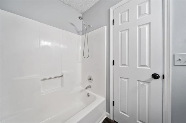 3232 Valley View St, Powder Springs, GA 30127 - bathroom featuring bathing tub / shower combination and a textured ceiling