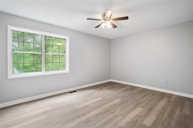 3232 Valley View St, Powder Springs, GA 30127 - empty room featuring plenty of natural light, a ceiling fan, wood finished floors, and a textured ceiling