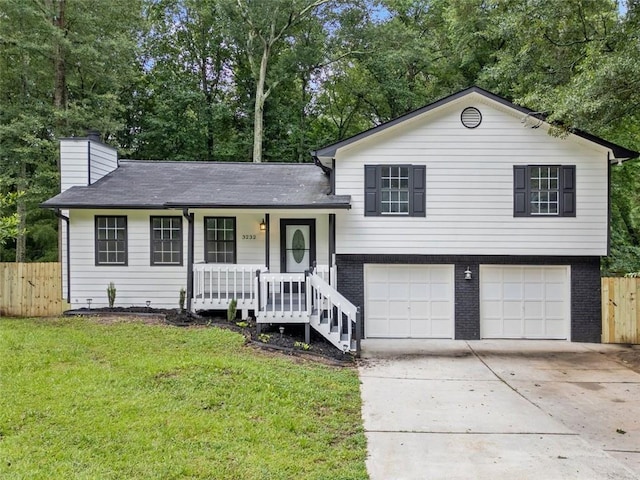 3232 Valley View St, Powder Springs, GA 30127 - tri-level home featuring covered porch, a garage, concrete driveway, brick siding, and a chimney