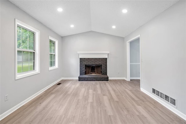 3232 Valley View St, Powder Springs, GA 30127 - unfurnished living room with light wood finished floors, vaulted ceiling, recessed lighting, and a brick fireplace