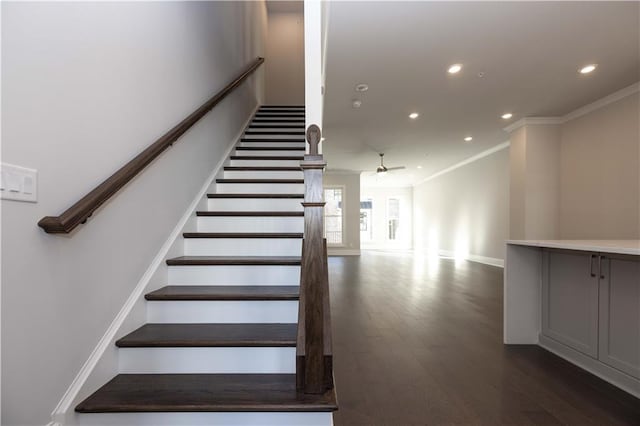 stairs featuring hardwood / wood-style flooring, ceiling fan, and ornamental molding